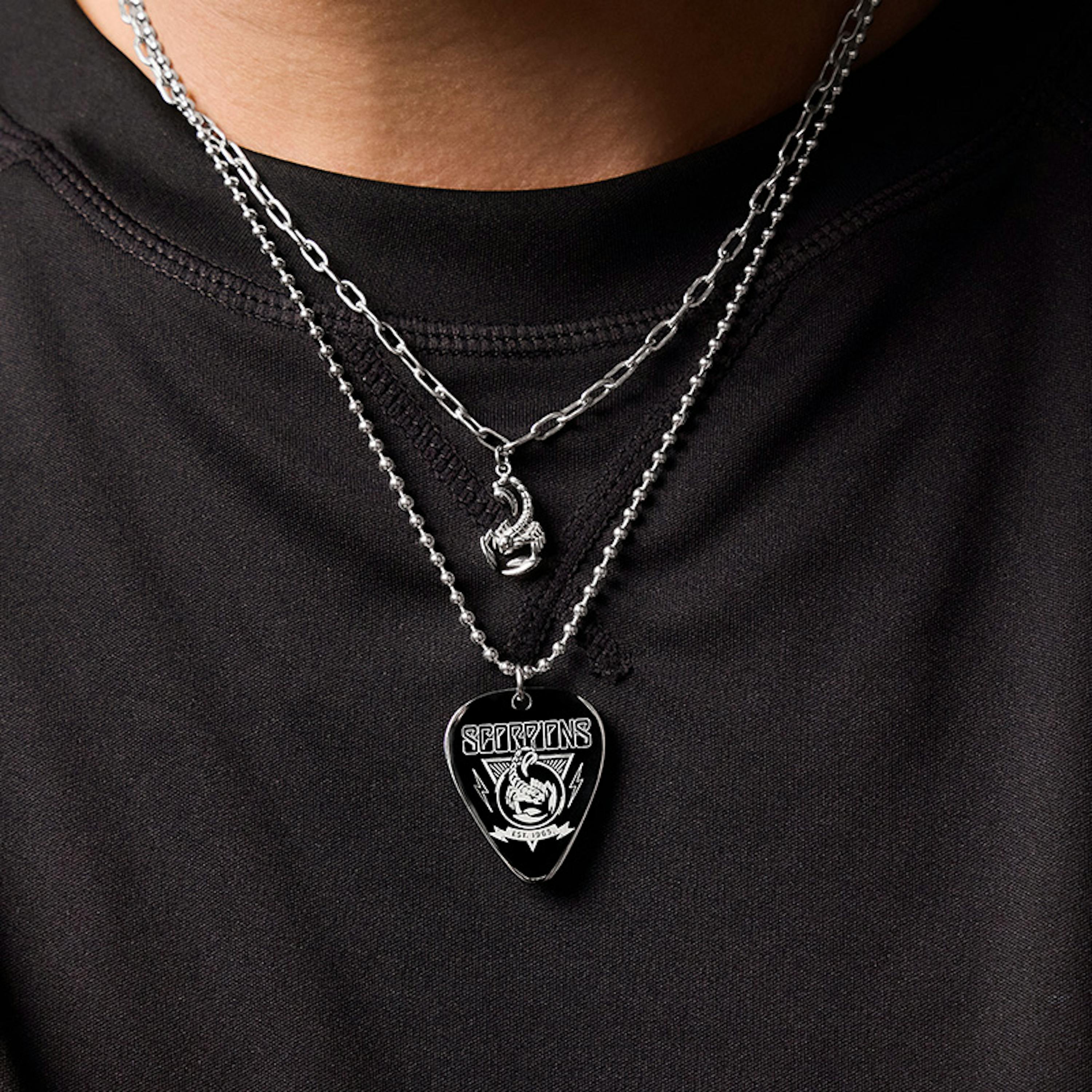 Mann trägt zwei Halsketten mit Scorpions Logo aus der neuen Amor x Scorpions Collection
